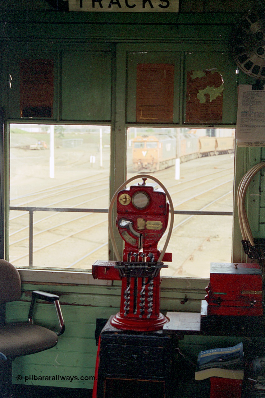 185-19
North Geelong C Signal Box, internal view of the miniature electric staff machine for the Gheringhap section with a staff ready in the hoop for V/Line grain train 9123 visible in the window.
