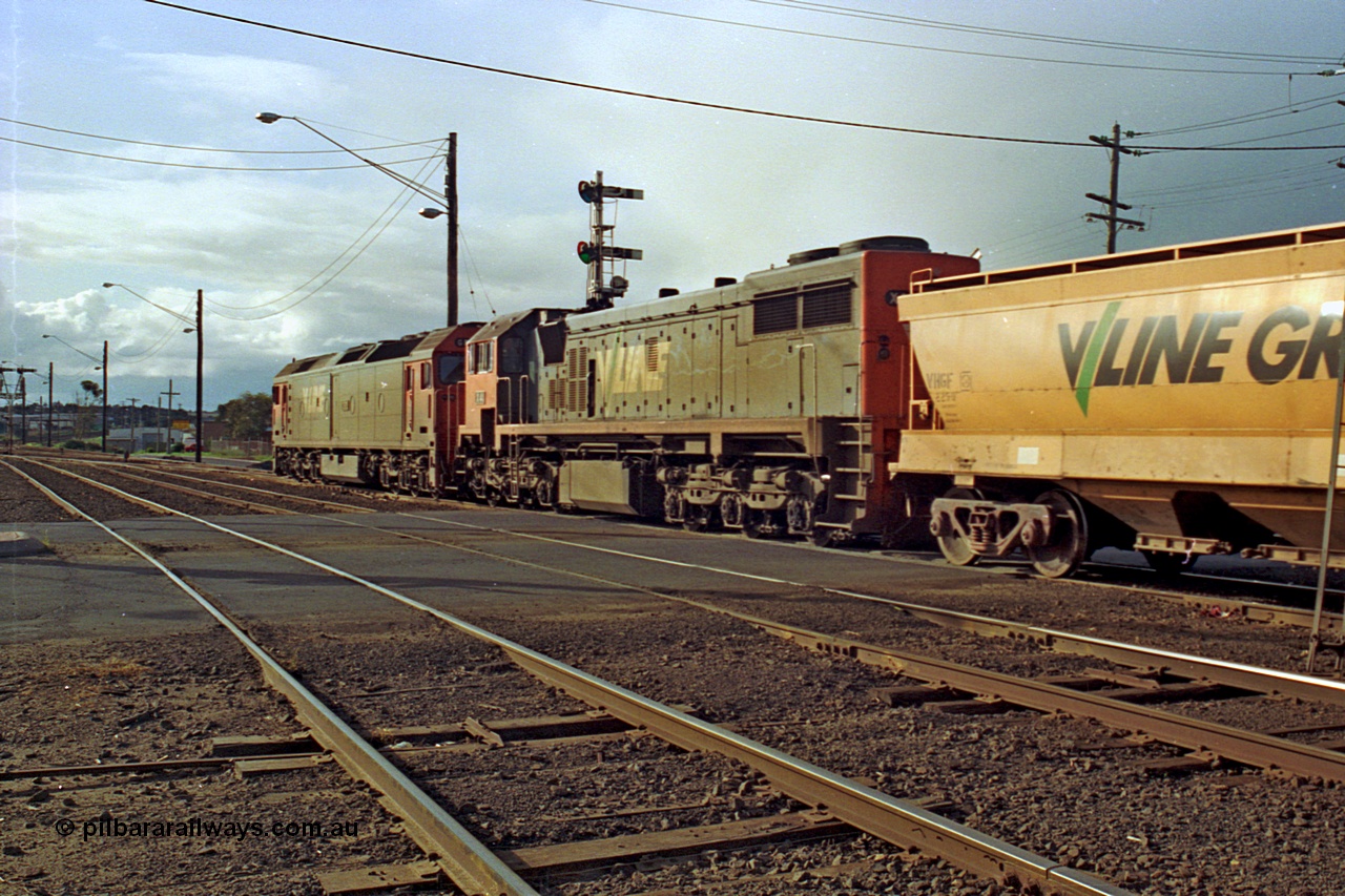 185-26
North Geelong C Box, Separation Street grade crossing, empty grain train behind G class G 528 Clyde Engineering EMD model JT26C-2SS serial 88-1258 and X class X 41 Clyde Engineering EMD model G26C serial 70-704 pass semaphore signal post 14 as they shunt up the mainline prior to setting back into the yard.
Keywords: X-class;X41;Clyde-Engineering-Granville-NSW;EMD;G26C;70-704;