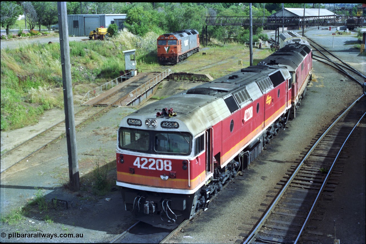 189-20
Albury, NSWSRA standard gauge loco depot with 422 class 42208 Clyde Engineering EMD model J26C serial 69-663 coupled to an 81 class and interloper V/Line G class G 519 Clyde Engineering EMD model JT26C-2SS serial 85-1232 rests off the turntable road, former trans-shipping shed in the background.
Keywords: 422-class;42208;Clyde-Engineering-Granville-NSW;EMD;J26C;69-663;