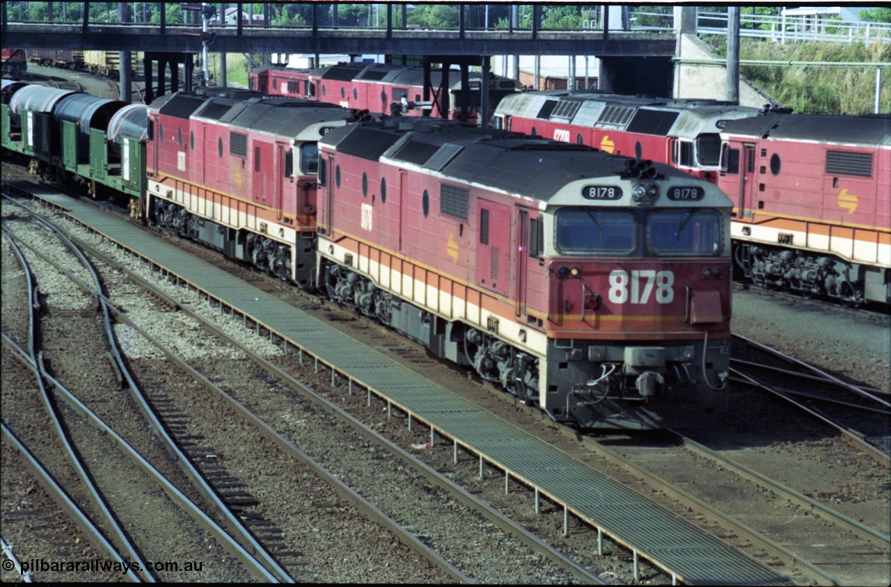 189-27
Albury yard view, double NSWSRA 81 class locomotives 8178 Clyde Engineering EMD model JT26C-2SS serial 85-1097 and 8170 serial 85-1089 wearing the candy livery on the point of an Victorian bound goods train, stabled locos stand in the depot to the right of the train.
Keywords: 81-class;8178;Clyde-Engineering-Kelso-NSW;EMD;JT26C-2SS;85-1097;
