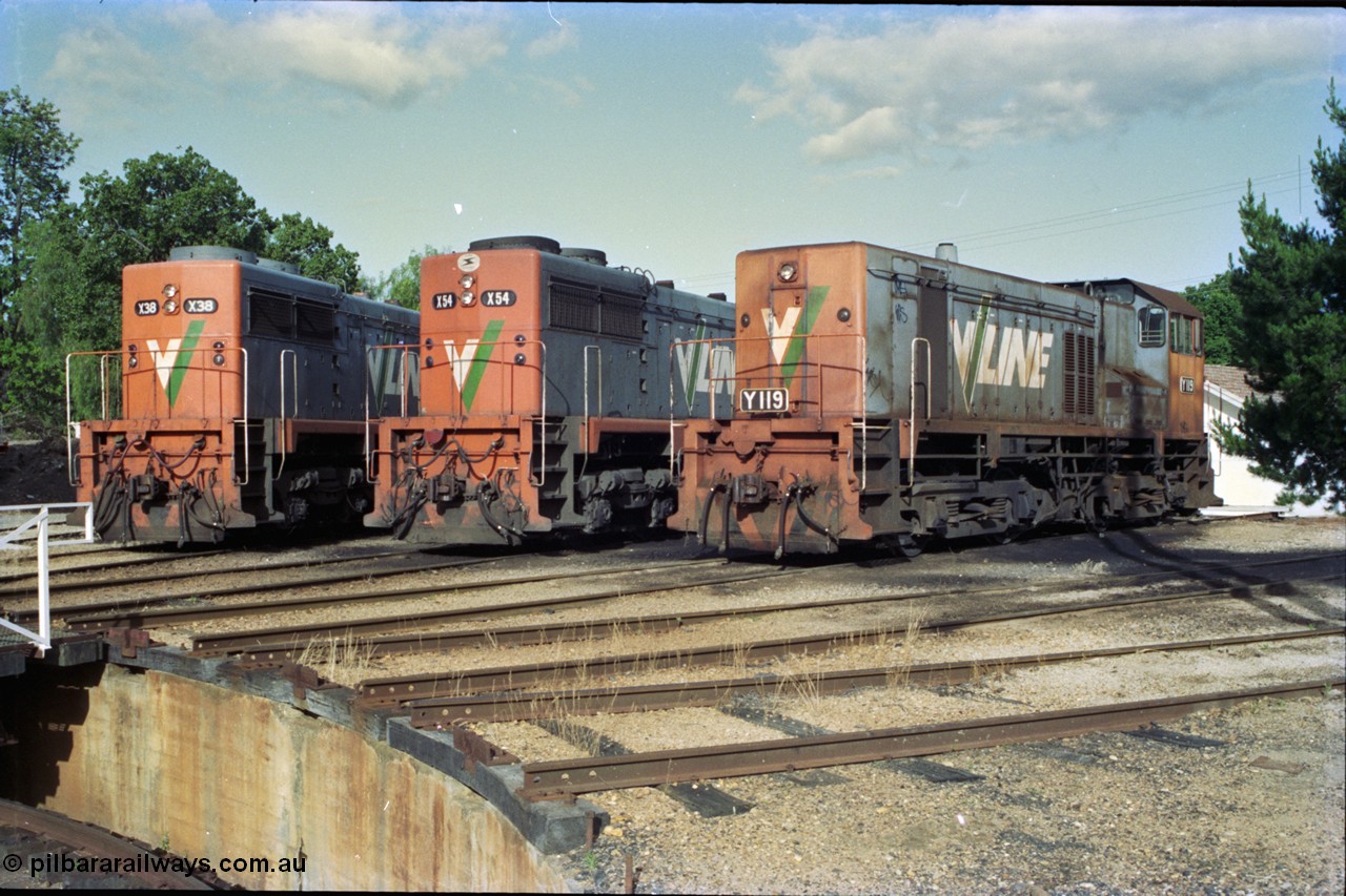 189-33
Wodonga, loco depot turntable radial roads, V/Line broad gauge locos lined up, 2nd series X class X 38 Clyde Engineering EMD model G26C serial 70-701 and 3rd series X class X 54 serial 75-801 with Y class Y 119 Clyde Engineering EMD model G6B serial 63-309, all long hood facing camera.
Keywords: Y-class;Y119;Clyde-Engineering-Granville-NSW;EMD;G6B;63-309;