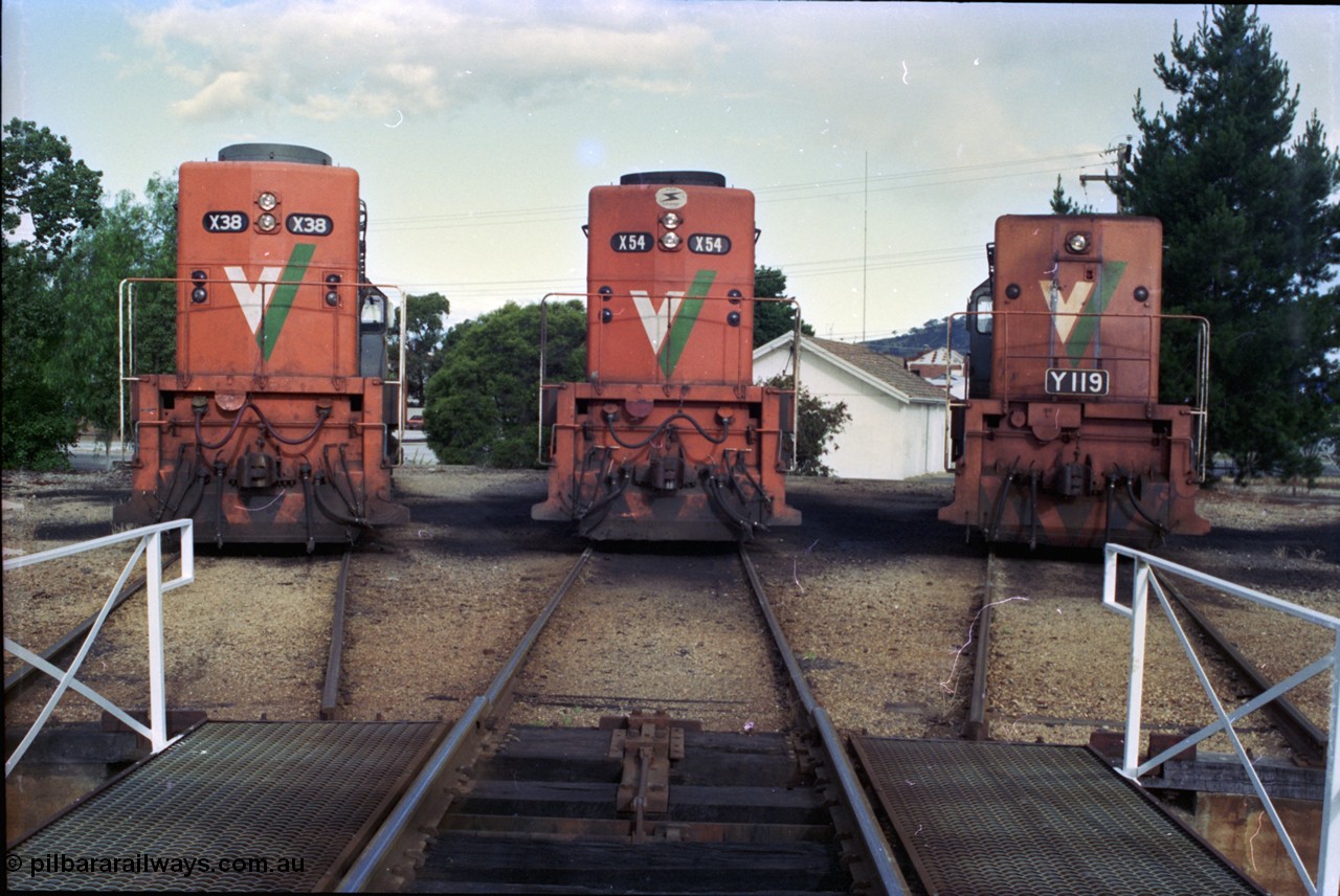 189-34
Wodonga, loco depot turntable radial roads, V/Line broad gauge locos lined up, 2nd series X class X 38 Clyde Engineering EMD model G26C serial 70-701 and 3rd series X class X 54 serial 75-801 with Y class Y 119 Clyde Engineering EMD model G6B serial 63-309, all long hood facing camera.
Keywords: X-class;X54;Clyde-Engineering-Rosewater-SA;EMD;G26C;75-801;