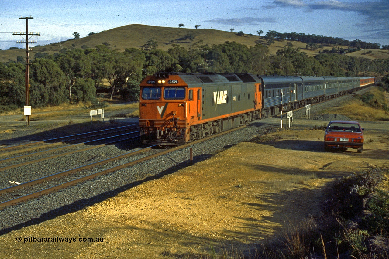 191-02
Wandong, O'Gradys Road grade crossing, near former Mathiesons Siding, UP Melbourne Express behind standard early 1990s V/Line G class power of Clyde Engineering built EMD model JT26C-2SS, G 521 serial 85-1234.
Keywords: G-class;G521;Clyde-Engineering-Rosewater-SA;EMD;JT26C-2SS;85-1234