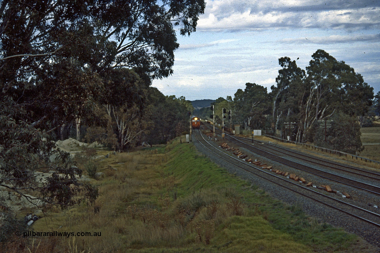 191-08
Seymour, looking south at the northern most Goulburn River bridge, end of Gordon Crescent, Seymour, quarry to the left. V/Line G class on down Inter-Capital Daylight on the standard gauge, broad gauge lines on the right, Seymour behind photographer.
