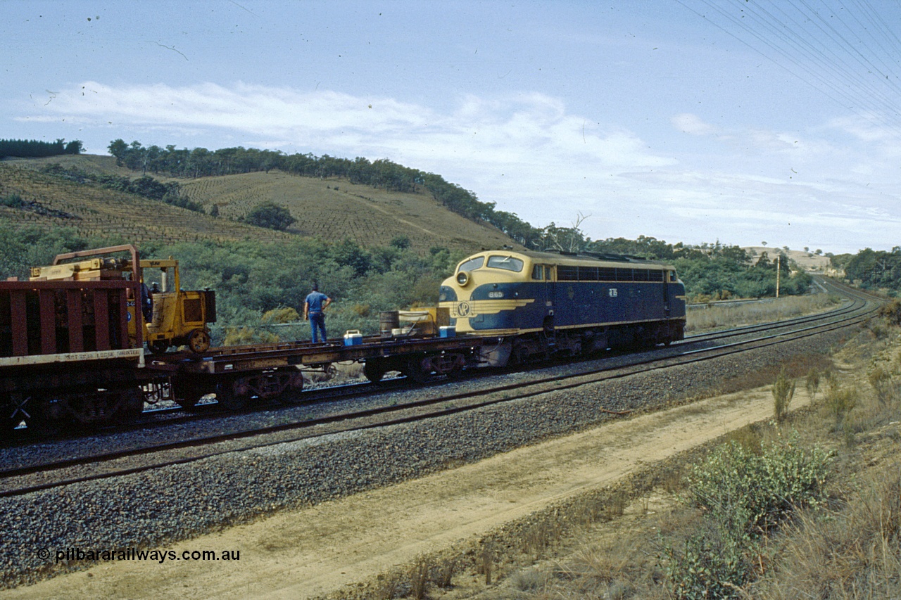 191-21
Kilmore East, Victorian Railways liveried B class B 65 Clyde Engineering EMD model ML2 serial ML2-6 leads an UP special sleeper discharge train as it discharges sleepers near the '37 mile', leading waggon is VZCA type VZCA 1 kicker transport waggon, former standard gauge signal post ES 1951 visible in the distance on a Sunday.
Keywords: B-class;B65;Clyde-Engineering-Granville-NSW;EMD;ML2;ML2-6;bulldog