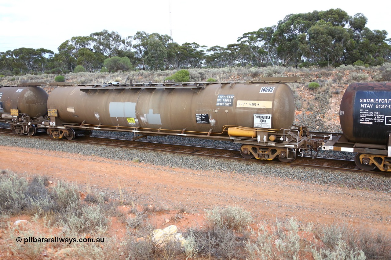 161116 5118
West Kalgoorlie, Shell fuel train 3442, tank waggon ATPY 14582, built by Westrail Midland Workshops 1976 as narrow gauge type JPA, one of eight, in 1985 recoded to JPAA and then WJPA on SG. Fitted with type F InterLock couplers.
Keywords: ATBY-type;ATBY14582;Westrail-Midland-WS;JPA-type;JPAA-type;WJPA-type;