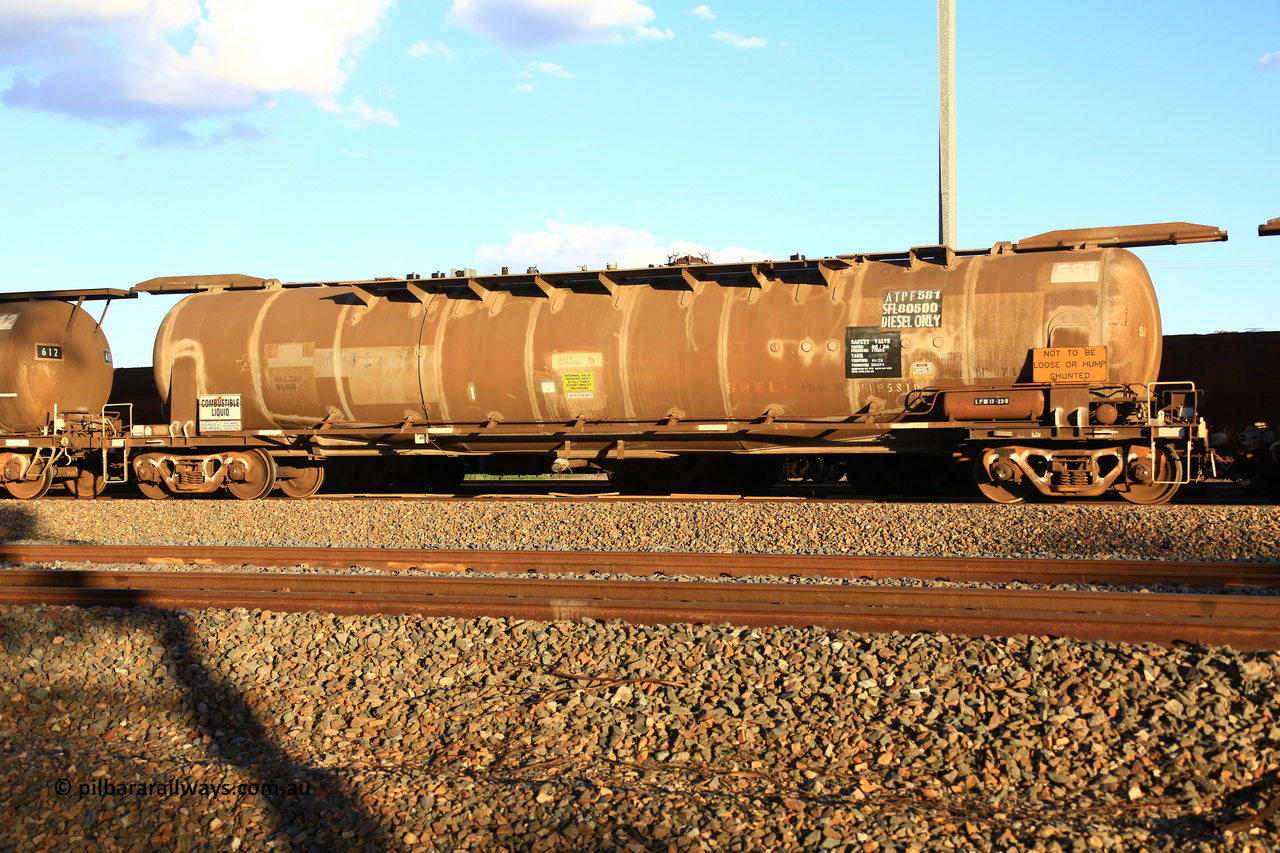 240328 3191
West Kalgoorlie, Viva Energy's APTF type fuel tank waggon ATPF 581 built by WAGR Midland Workshops in 1976 for Shell, in a batch of three, as a WJP type 80,660 litre, one compartment one dome tank waggon, with a SFL of 80,500 litres, fitted with type F InterLock couplers. Pacific National empty fuel train 5445 to Esperance. March 28, 2024.
Keywords: ATPF-type;ATPF581;WAGR-Midland-WS;WJP-type;