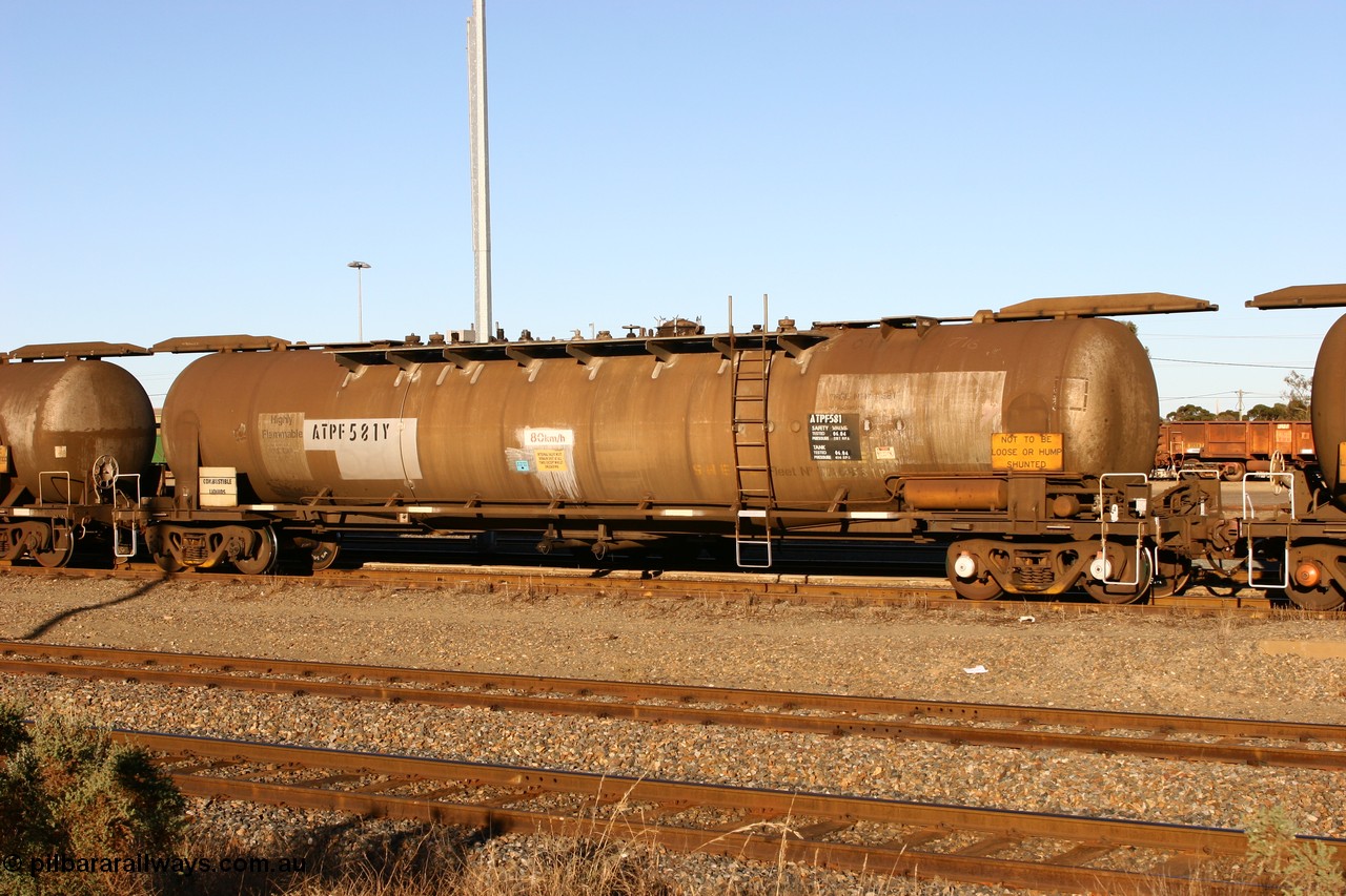 060528 4649 ATPF581Y
West Kalgoorlie, ATPF 581 fuel tank waggon built by WAGR Midland Workshops 1976 for Shell as type WJP 80.66 kL one compartment one dome, fitted with type F InterLock couplers.
Keywords: ATPF-type;ATPF581;WAGR-Midland-WS;WJP-type;JPC-type;