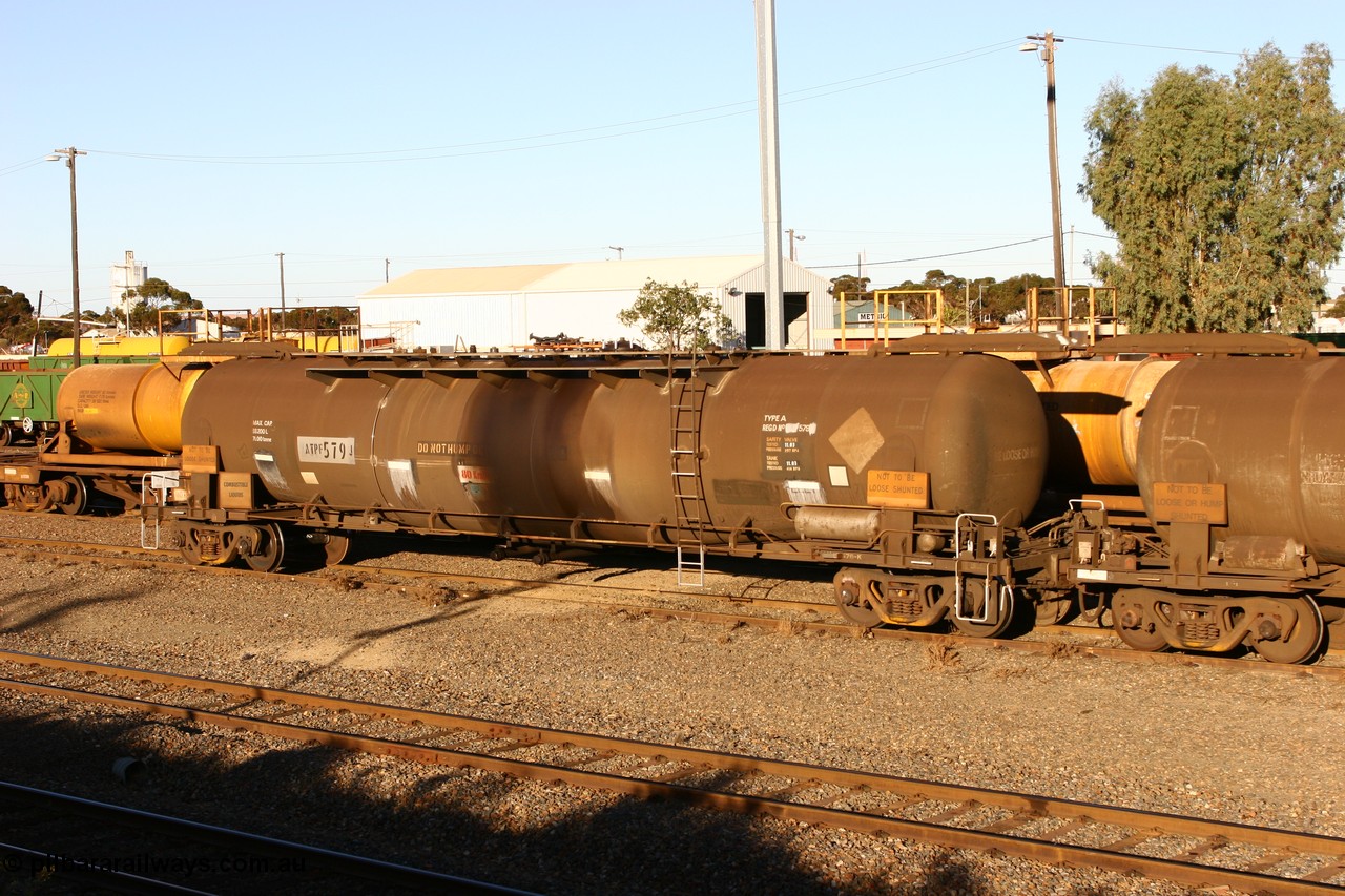 060528 4664
West Kalgoorlie, ATPF 579 fuel tank waggon built by WAGR Midland Workshops 1974 for Shell as WJP type 80.66 kL one compartment one dome, fitted with type F InterLock couplers.
Keywords: ATPF-type;ATPF579;WAGR-Midland-WS;WJP-type;