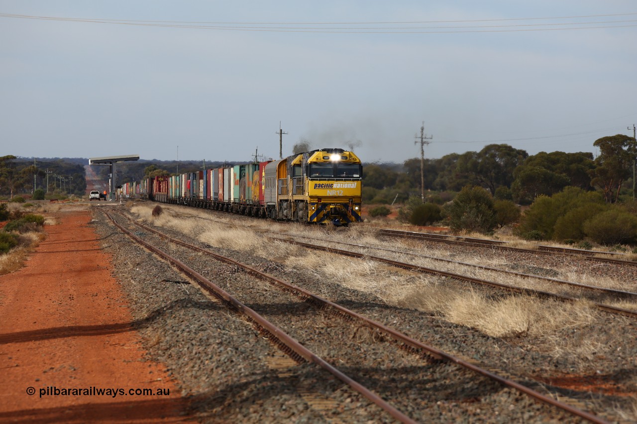 160523 2926
Parkeston, 7SP3 intermodal train, a pair of Goninan built GE model Cv40-9i NR class units NR 12 serial 7250-02/97-214 and NR 51 serial 7250-08/97-253 lead the train 'elephant style' out of the dip and along the mainline at the 1776 km. The PN local is in the car at the gantry performing a roll-by, the track on the left is the Engineers Siding.
Keywords: NR-class;NR12;Goninan;GE;Cv40-9i;7250-02/97-214;