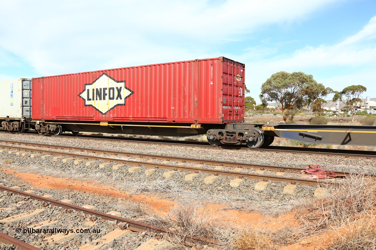 160523 2971
Parkeston, 7SP3 intermodal train, RRQY 8519 platform 5 of 5-pack articulated skel waggon set, built by Qiqihar Rollingstock Works, China, loaded with a 48' Linfox container DRC 841.
Keywords: RRQY-type;RRQY8519;Qiqihar-Rollingstock-Works-China;