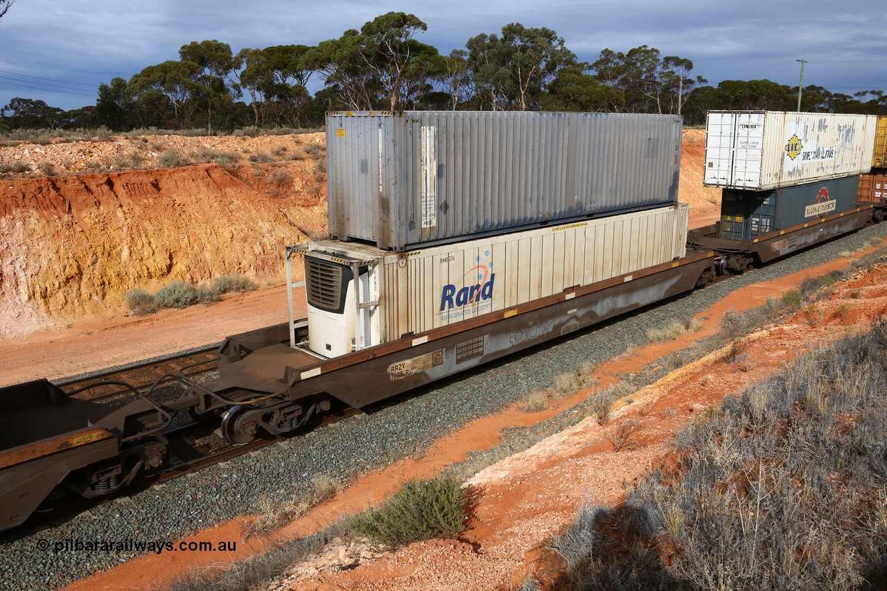 160524 3826
West Kalgoorlie, 2PM6 intermodal train, RRZY type five unit bar coupled well container waggon set RRZY 7028 platform 3, originally built by Goninan in a batch of twenty six as RQZY type for National Rail, recoded when repaired. Loaded with a Rand Refrigerated Logistics 46' 6