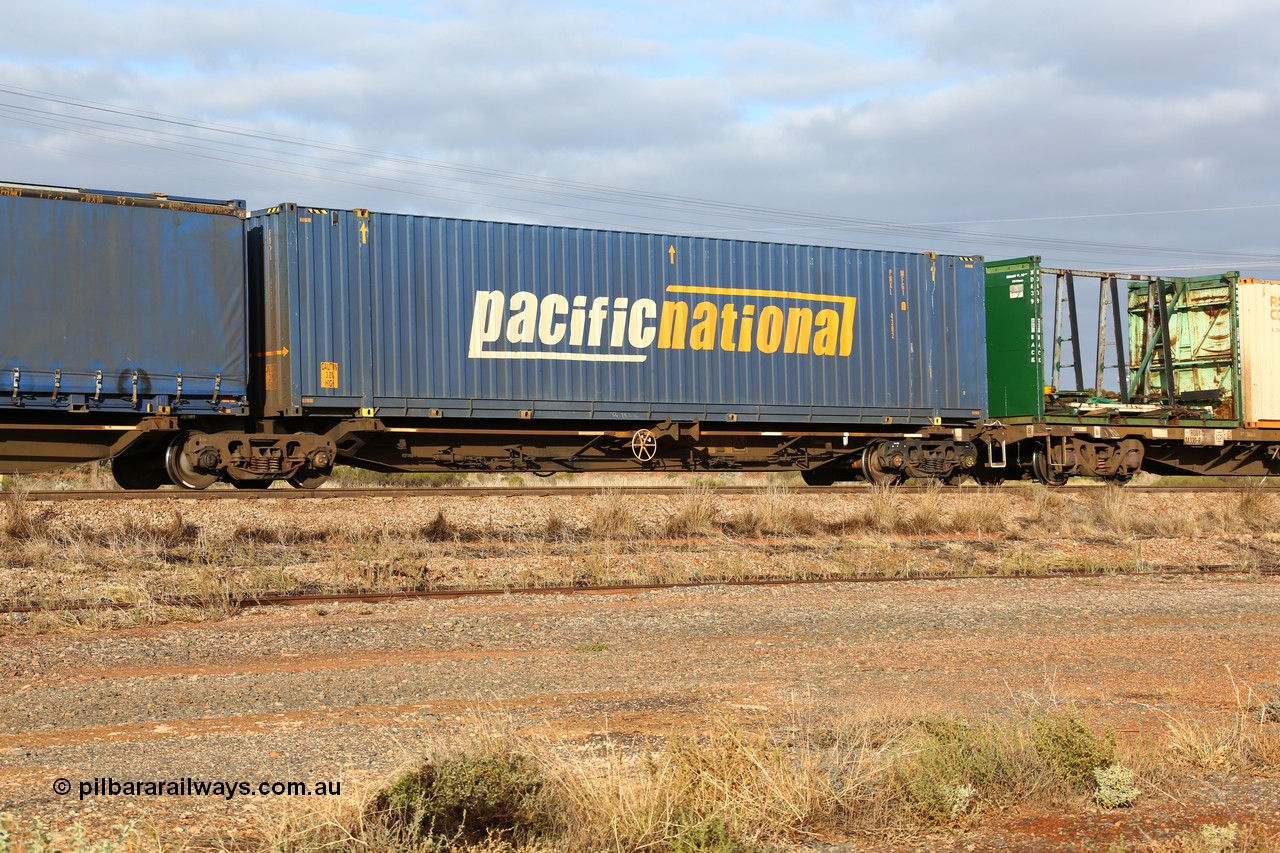 160525 4518
Parkeston, 3PM7 priority service train, RRQY 7327 platform 5 of 5-pack articulated skel waggon set built by Qiqihar Rollingstock Works China in 2005 for Pacific National, with a 48' Pacific National box PNXL 4302.
Keywords: RRQY-type;RRQY7327;Qiqihar-Rollingstock-Works-China;