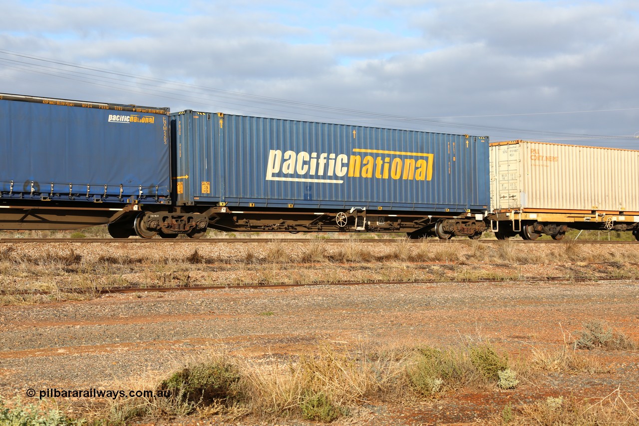160525 4530
Parkeston, 3PM7 priority service train, RRQY 8344 platform 1 of 5-pack articulated skel waggon set the last of a batch of 41 built by Qiqihar Rollingstock Works China in 2005 for Pacific National, with a Pacific National 48' box PNXD 4188.
Keywords: RRQY-type;RRQY8344;Qiqihar-Rollingstock-Works-China;