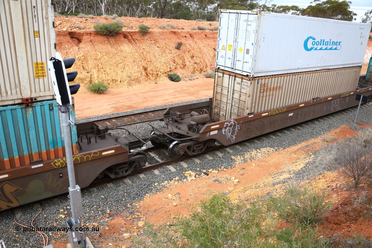 160526 5235
West Kalgoorlie, 4PM6 intermodal train, view of the bar coupling and tank arrangement on platform 4 of 5-pack RRRY 7004 well waggon set, one of nineteen built in China at Zhuzhou Rolling Stock Works for Goninan in 2005, double stacked with two 40' boxes, SCR Rail Containers AUSU 410187 and Cooltainer insulated box CTAU 411011 on top.
Keywords: RRRY-type;RRRY7004;CSR-Zhuzhou-Rolling-Stock-Works-China;