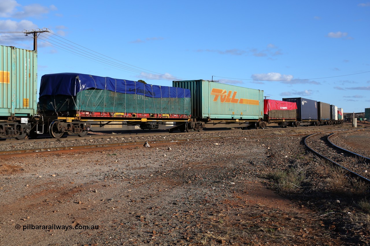 160528 8339
Parkeston, 5SP5 intermodal train, RRQY 8523 the final unit of a batch of twenty five five pack articulated waggon sets built in 2015 by Qiqihar Rollingstock Works in China. Seen here loaded with a K&S 40' flatrack KT 400233 with a John Stepnell Transport tarped load, 48' Toll TCML 48533, K&S 40' flatrack and two 40' containers.
Keywords: RRQY-type;RRQY8523;Qiqihar-Rollingstock-Works-China;
