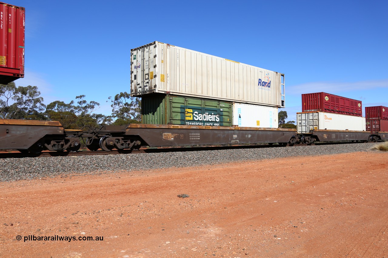 160528 8445
Binduli, intermodal train 6PM6, RRZY type five unit bar coupled well container waggon set RRZY 7023 platform 3, originally built by Goninan in a batch of twenty six RQZY type for National Rail, recoded when repaired. Loaded with a 20' Sadleirs 2NG8 type side door container RCS 2116 and a Royal Wolf 25G1 type container RWPU 200917 double stacked with a Rand Refrigerated Logistics 46' 6