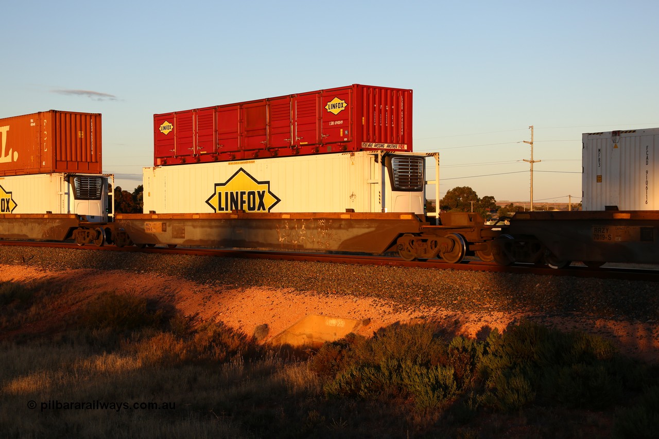160601 10107
West Kalgoorlie, 2MP5 intermodal train, RRZY 7019 platform 4 of 5-pack well waggon set of twenty six waggon sets built by Goninan in 1995-96 for National Rail as RQZY, later rebuilt and recoded as RRZY, double stacked with a Linfox 40' half height side door unit LSDU 6940049 and Linfox 46' 6