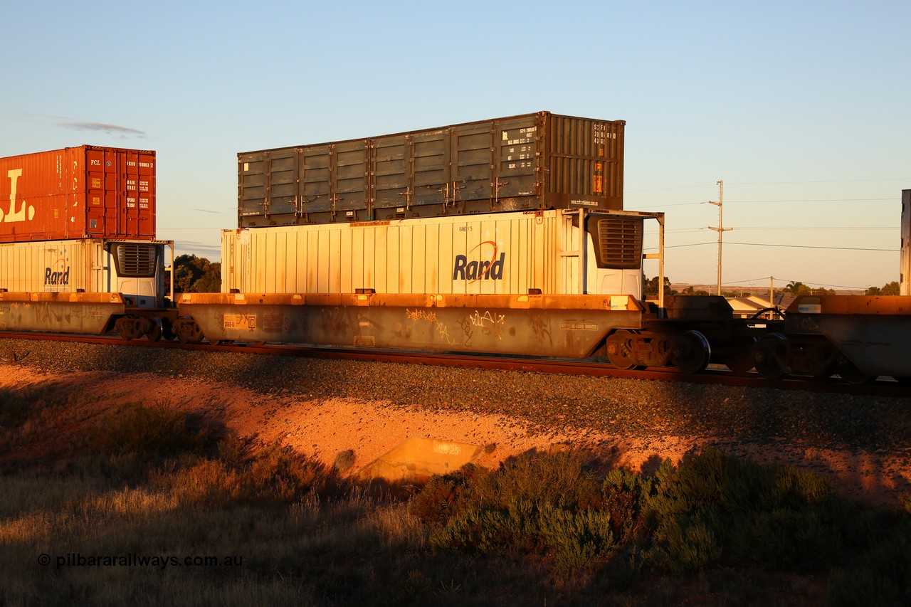 160601 10112
West Kalgoorlie, 2MP5 intermodal train, RQZY 7065 platform 4 of 5-pack well waggon set one of thirty two waggon sets built by Goninan NSW for National Rail in 1995-96, double stacked with an SCF 40' 40G2 type half height side door SCFU 200560[0] and Rand Refrigerated Logistics 46' 6