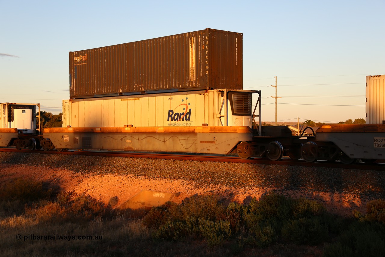 160601 10129
West Kalgoorlie, 2MP5 intermodal train, RQZY 7036 platform 2 of 5-pack well waggon set one of thirty two waggon sets built by Goninan NSW for National Rail in 1995-96, double stacked with an Austrans 40' 4EG1 type sea2rail box AUSU 408115[2] and Rand Refrigerated Logistics 46' 6