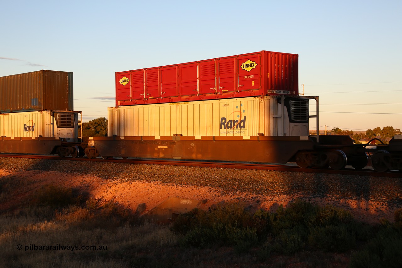 160601 10146
West Kalgoorlie, 2MP5 intermodal train, RRZY 7008 platform 2 of 5-pack well waggon set, the prototype of the RQZY type, first of twenty six sets built by Goninan in 1995-96 for National Rail, later rebuilt and recoded RRZY, double stacked with a Linfox 40' half height side door container LSDU 694007 and Rand Refrigerated Logistics 46' 6