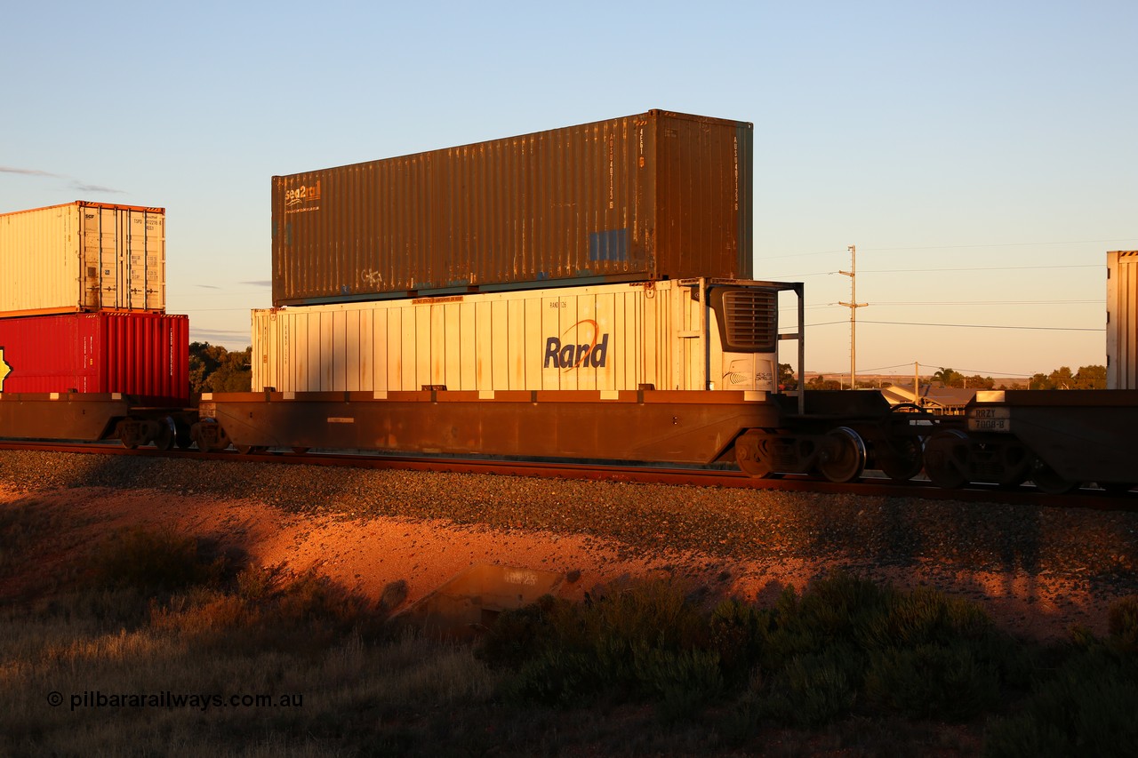 160601 10147
West Kalgoorlie, 2MP5 intermodal train, RRZY 7008 platform 3 of 5-pack well waggon set, the prototype of the RQZY type, first of twenty six sets built by Goninan in 1995-96 for National Rail, later rebuilt and recoded RRZY, double stacked with an SCF sea2rail 40' 4EG1 type box AUSU 407123[6] and Rand Refrigerated Logistic 46' 6
