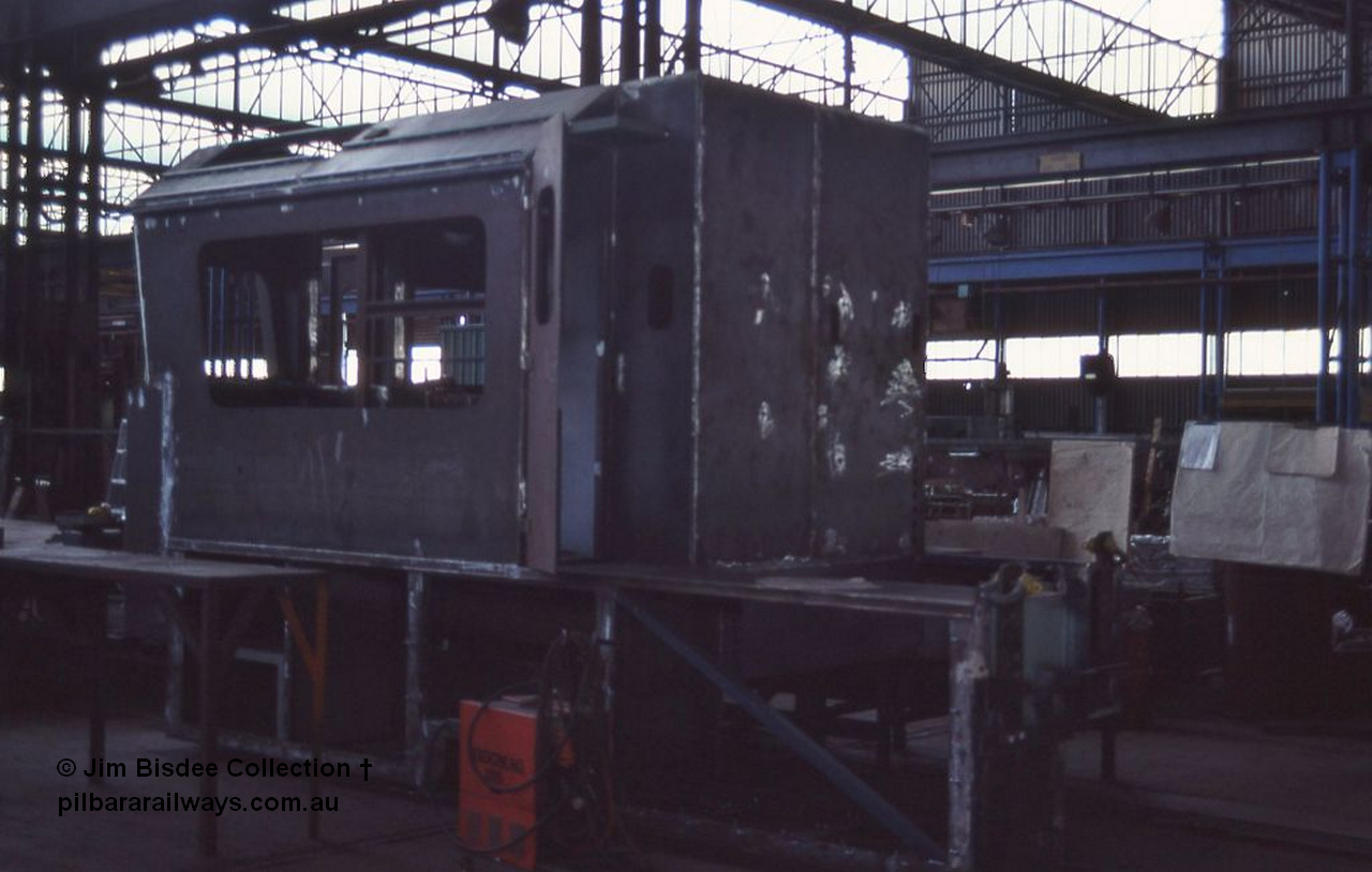 1047 001
Welshpool, Goninan Open Day 27th August, 1988. Brand new Pilbara cab being constructed for GE CM39-8 locomotive 5633 serial 5831-12 / 88-082 under construction for Mt Newman Mining.
Jim Bisdee photo.
Keywords: 5633;Goninan;GE;CM39-8;5831-12/88-082;