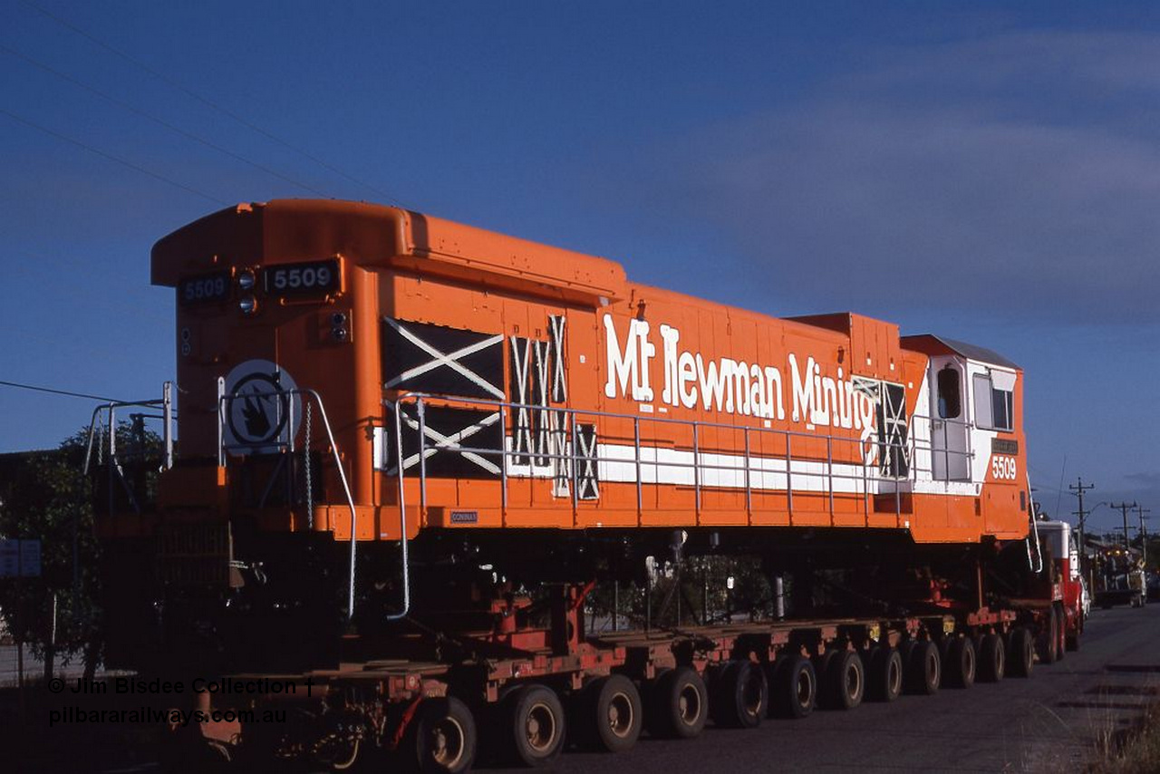 1062 001
Welshpool, Goninan, Mt Newman Mining's GE C36-7M rebuild unit 5509 serial 4839-05 / 87-074 being road hauled to Port Hedland by Bell on a ninety four wheel float. This unit was rebuild from AE Goodwin ALCo C636 unit 5452 serial G6012-1. May 1987.
Jim Bisdee photo.
Keywords: 5509;Goninan;GE;C36-7M;4839-05/87-074;rebuild;AE-Goodwin;ALCo;C636;5452;G6012-1;