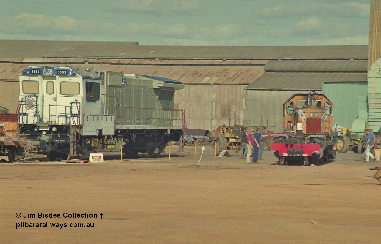 16941
Bassendean, Goninan GE CM40-8M rebuild unit for BHP Iron Ore 5653 'Chiba' serial 8412-10 / 93-144 sits out the back on shop bogies still under construction in the October 1993 image as the Goninan shunt loco moves the frame of a steam engine. 5653 was rebuilt from Mt Newman Mining AE Goodwin built ALCo M636 5484 serial G6061-5.
Jim Bisdee photo.
Keywords: 5653;Goninan;GE;CM40-8M;8412-10/93-144;rebuild;AE-Goodwin;ALCo;M636C;5484;G6061-5;