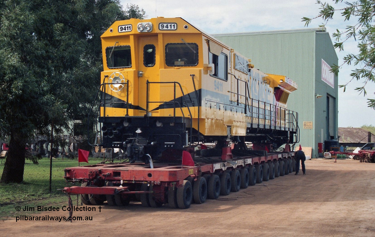 20956
Bassendean, Goninan workshops, sitting outside the gates waiting to head to Cape Lambert, Robe River Goninan GE CM40-8M rebuild unit 9411 serial 8206-02 / 92-125, retains its original Robe River road number on a hundred and twenty wheel road float. 9411 was rebuilt into the GE CM40-8M unit from AE Goodwin ALCo M636 serial G6060-2. February 1992.
Jim Bisdee photo.
Keywords: 9411;Goninan;GE;CM40-8M;8206-02/92-125;rebuild;AE-Goodwin;MLW-ALCo;M636;G6060-2;