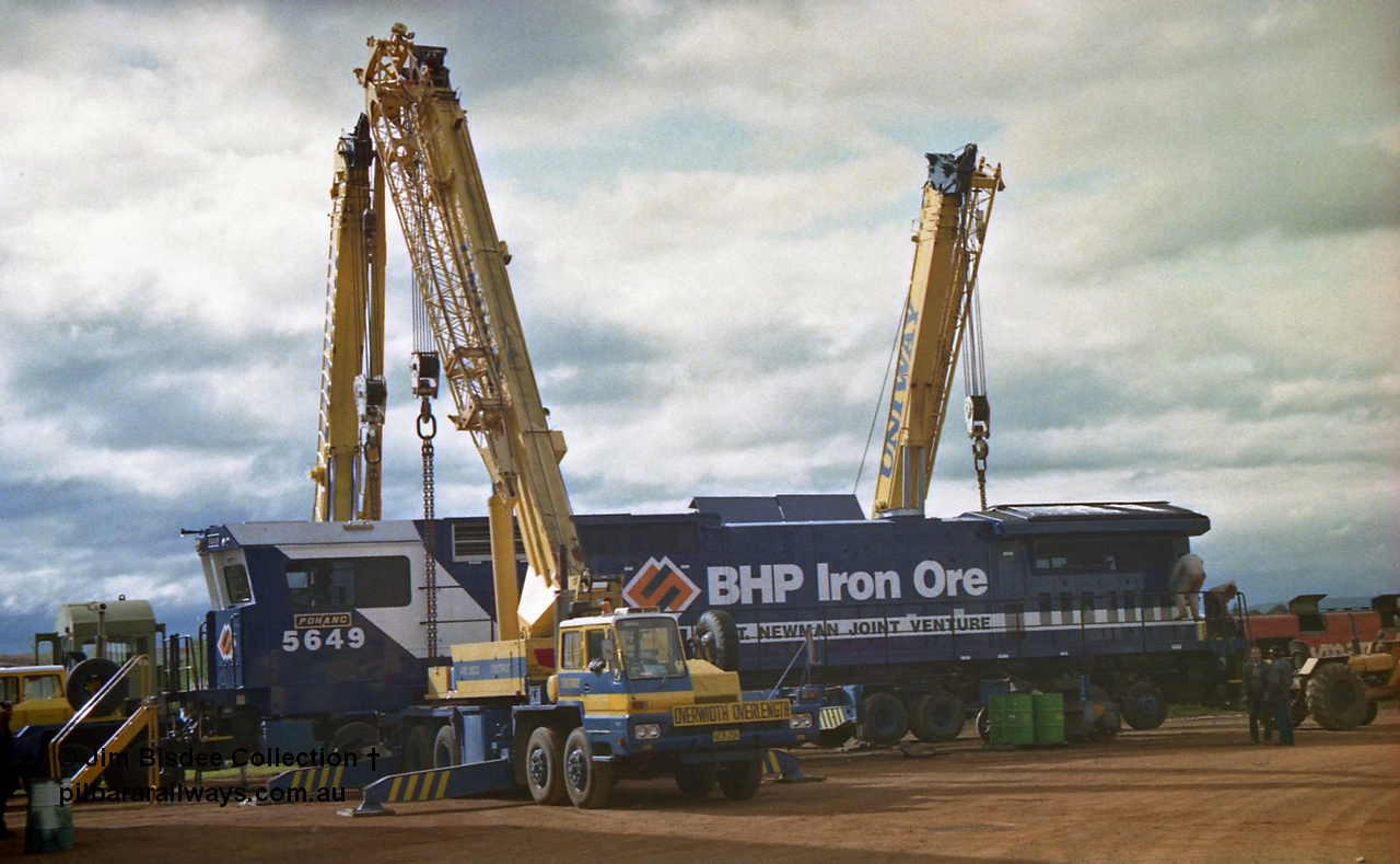 23882
Bassendean, Goninan workshops, BHP Iron Ore GE CM40-8M rebuild unit 5649 'Pohang' serial 8412-07 / 93-140 is being lifted up and prepped for road haulage to Port Hedland. 5649 was rebuilt from AE Goodwin ALCo M636 unit 5473 serial G6047-5. July 1993.
Jim Bisdee photo.
Keywords: 5649;Goninan;GE;CM40-8M;8412-07/93-140;rebuild;AE-Goodwin;ALCo;M636C;5473;G6047-5;
