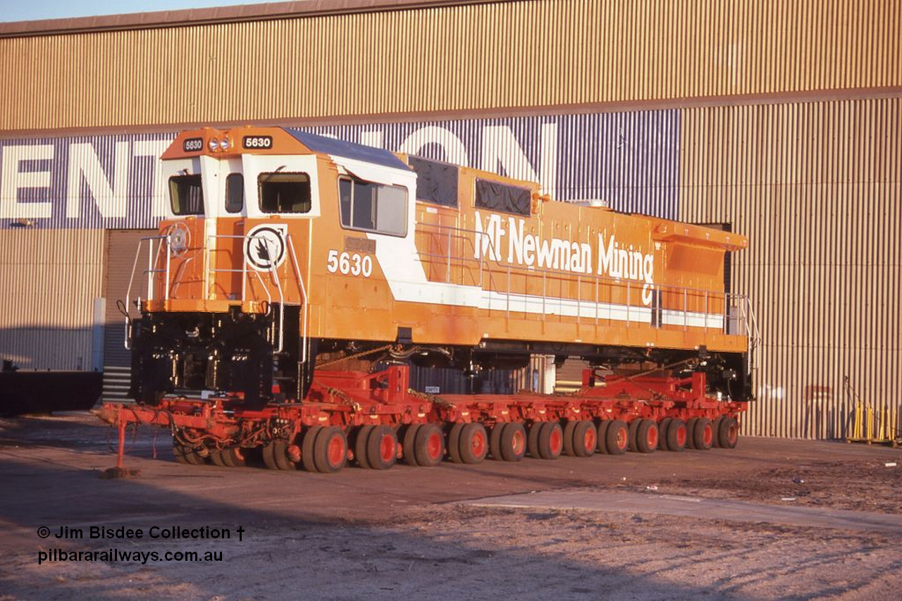 6991 001 Welshpool 19880904
Welshpool, Goninan workshops, brand new Mt Newman Mining's GE model CM39-8 loco 5630 'Zeus' serial 5831-09 / 88-079 is lashed down on a road transport float ready for haulage to Port Hedland in this 4th September 1988 image.
Jim Bisdee photo.
Keywords: 5630;Goninan;GE;CM39-8;5831-09/88-079;