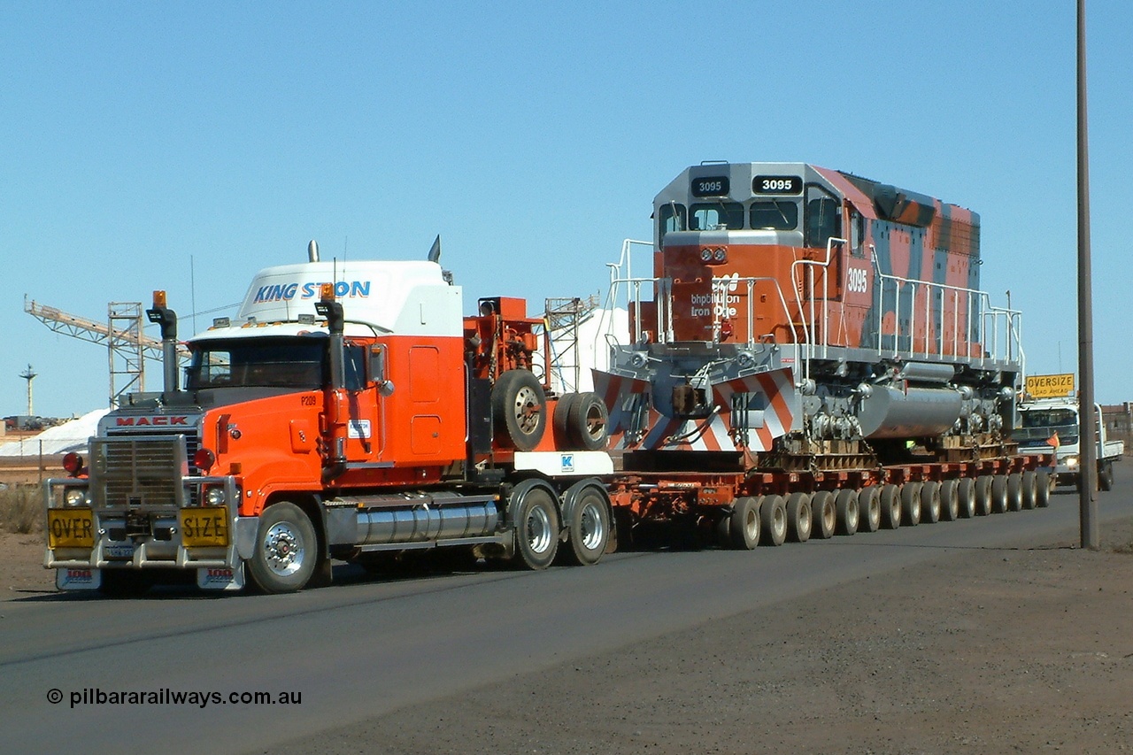 040807 112612r
Port Hedland, Gilbert Street, BHP Billiton EMD SD40R unit 3095 serial 33677 originally Southern Pacific SD40 SP 8485 being road delivered by Kingston Heavy Haulage on a 168 wheel float 7th August 2004.
Keywords: 3095;EMD;SD40R;33677/7083-7;SD40;SP8485;