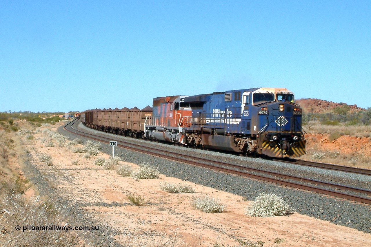 040810 101005r
Abydos Siding, BHP GE AC6000 6075 'Newman' serial 51067 leads EMD SD40R unit 3090 serial 33680 originally Southern Pacific SD40 SP 8488 on the mainline having passed Tamper 2. The 330 board is the 330 waggon train clearance point from the north end switch. 10th August 2004.
Keywords: 6075;GE;AC6000;51067;