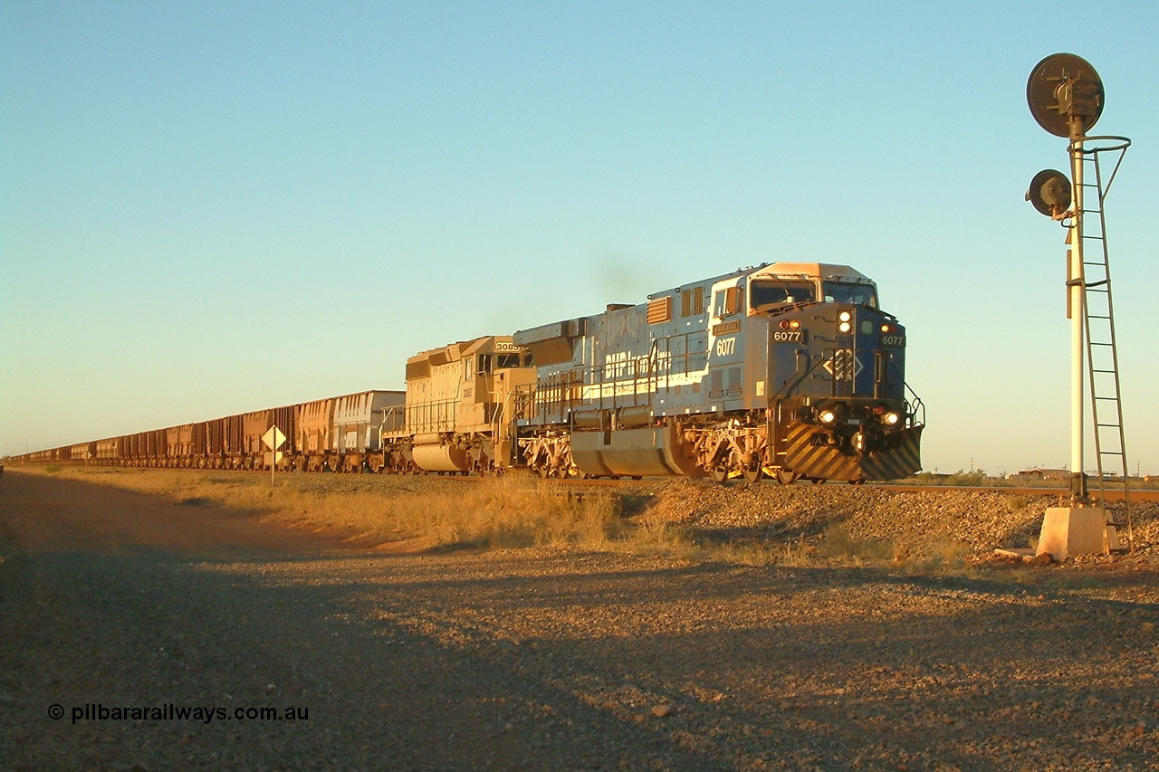 040811 173538r
Goldsworthy Junction BHP GE AC6000 6077 'Nimingarra' serial 51069 and EMD SD40-2 3085 serial 786170-25 formally Union Pacific UP 3523 are in charge of an empty train at signal TR13 (transfer road switch, Goldsworthy Junction) mid-train units can just be seen in frame 11th August 2004.
Keywords: 6077;GE;AC6000;51069;
