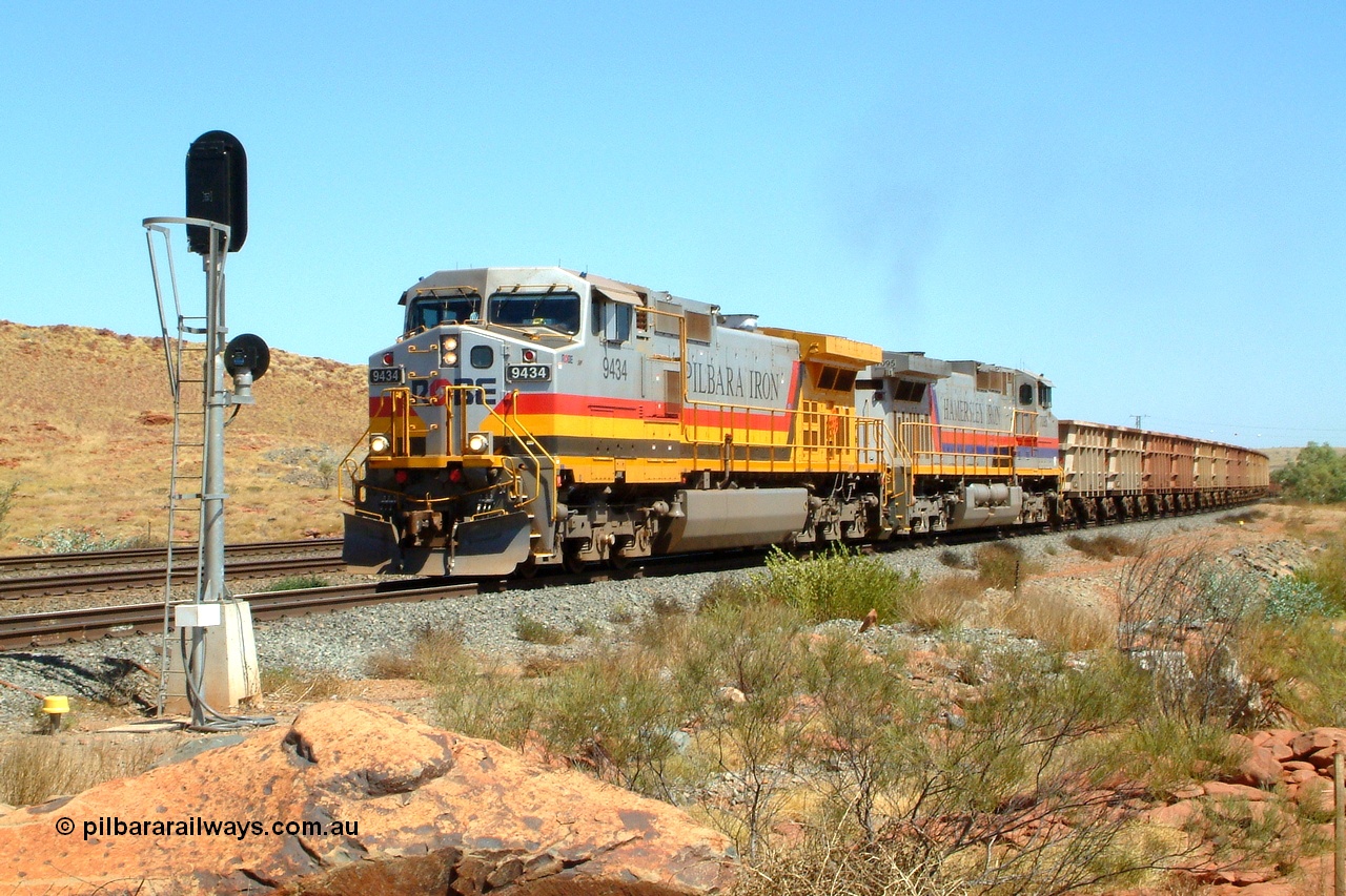 050110 100724r
Western Creek junction, Robe River owned General Electric Dash 9-44CW unit 9434 serial 54767 in Pilbara Iron livery leads similar Hamersley Iron owned unit 7095 serial 52842 in original livery off the interconnecting line from the Cape Lambert - Deepdale line onto the Dampier - Tom Price line with an empty train bound for West Angelas. This junction is known as Western Creek and the double track of Emu can be seen to the left. Monday 10th January 2005.
Keywords: 9434;GE;Dash-9-44CW;54767;