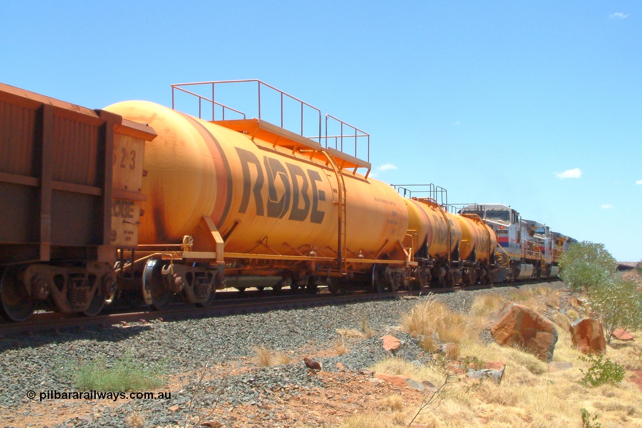 050110 122348r
Maitland Siding, an empty Mesa J bound train runs along the passing track crossing a loaded sitting on the mainline. The tank waggons behind the locos are 8001 and 8002 both built in 1972 with a 45,000 litre capacity and 8003 built in 1979 with a 100,000 litre capacity, all three were built by Comeng NSW. Monday 10th January 2005.
Keywords: 8003;Comeng-NSW;