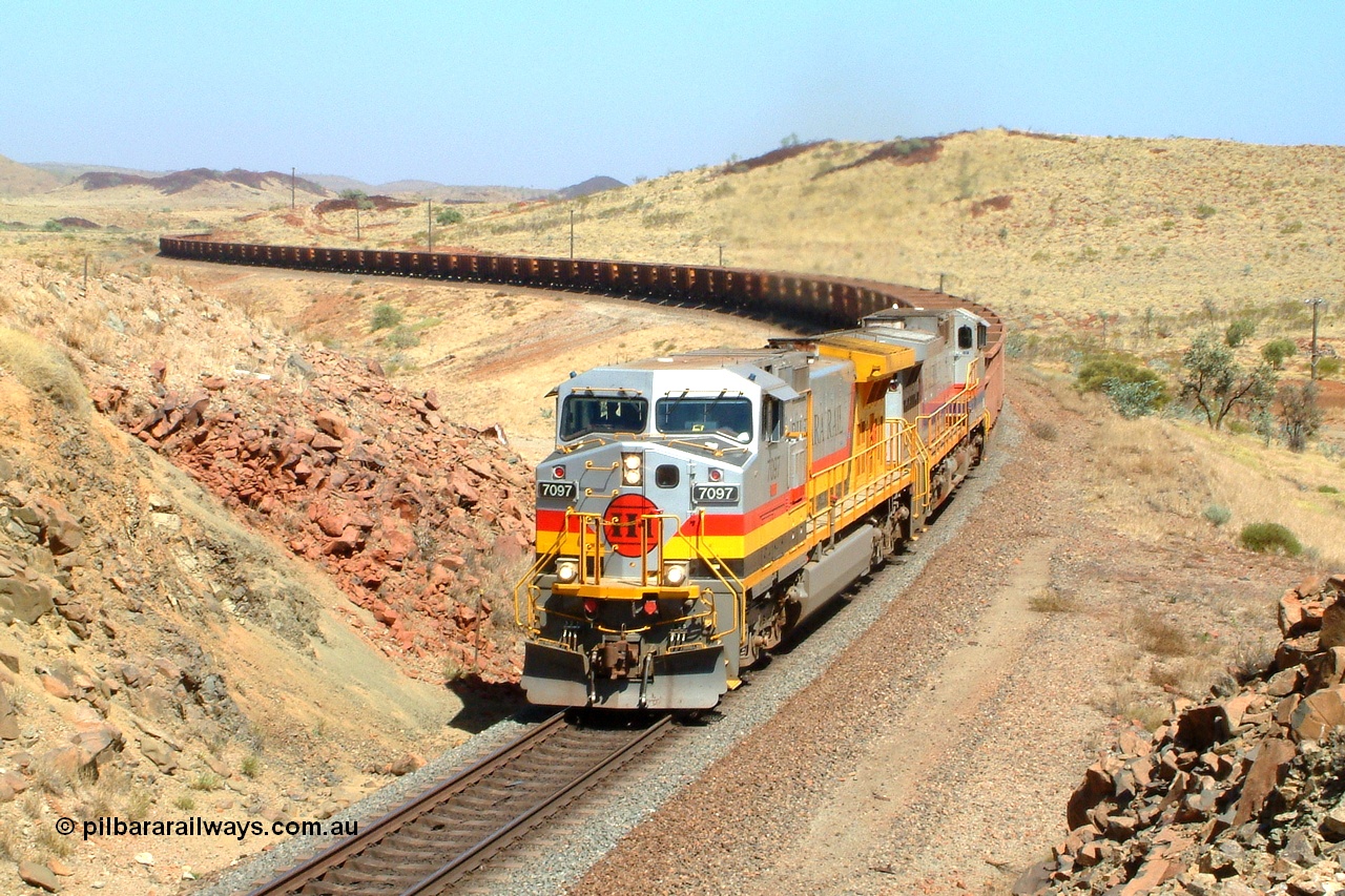 050111 095514r
Dugite Siding, Hamersley Iron owned Pilbara Rail's only named General Electric built Dash 9-44CW locomotive 7097 'Ken Onley' serial 54160 leads sister unit 7093 serial 47772 the final unit of the original order in original livery as they climb the range near the 67 km with an empty working on the Dampier mainline. Tuesday 11th January 2005.
Keywords: 7097;GE;Dash-9-44CW;54160;