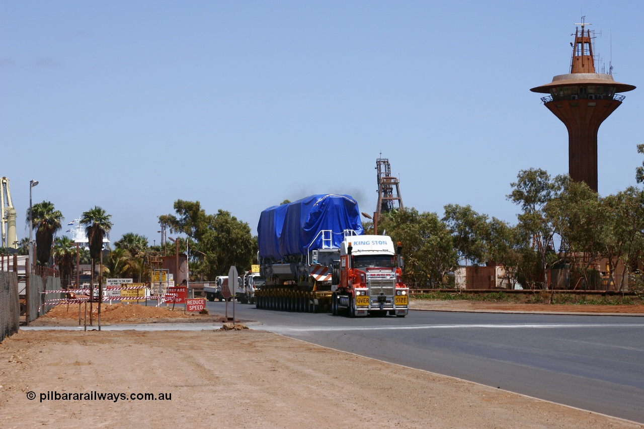 051022 5797r
Port Hedland port, BHP Billiton's first Electro-Motive SD70ACe to be off loaded in Australia 4311 serial 20038540-012 under tarp seen leaving the port en route to Nelson Point for unloading onto the rails 22nd October 2005.
Keywords: 4311;Electro-Motive-London-Ontario;EMD;SD70ACe/LC;20038540-012;