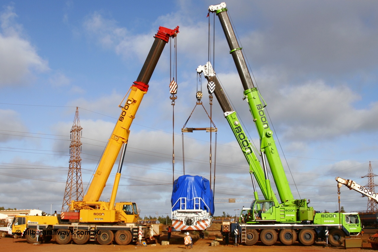051023 6119r
Nelson Point hard stand, BHP Billiton's brand new Electro-Motive built SD70ACe/LC unit 4301 serial 20038540-002 is lowered onto the rails by three Boom Logistics cranes, a 200, 160 and 120 tonne units. Sunday 23rd October 2005.
Keywords: 4301;Electro-Motive;EMD;SD70ACe/LC;20038540-002;