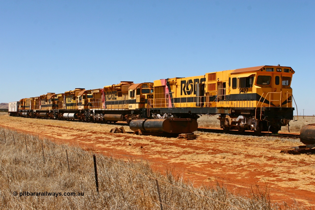 061209 8225r
Seven Mile on 38 Road, stored and stripped the Robe River ALCo units await their fate. Comeng WA ALCo rebuild C636R unit 9426 has already been sent to Perth and sister 9427 is stripped and ready to follow. The other units behind 9427 are ALCo M636 units 9416, 9413, 9415 and 9412. 9th December 2006.
Keywords: 9427;Comeng-WA;C636R;WA143-2;rebuild;ALCo;Schenectady-NY;C636;Conrail;6781;3499-2;