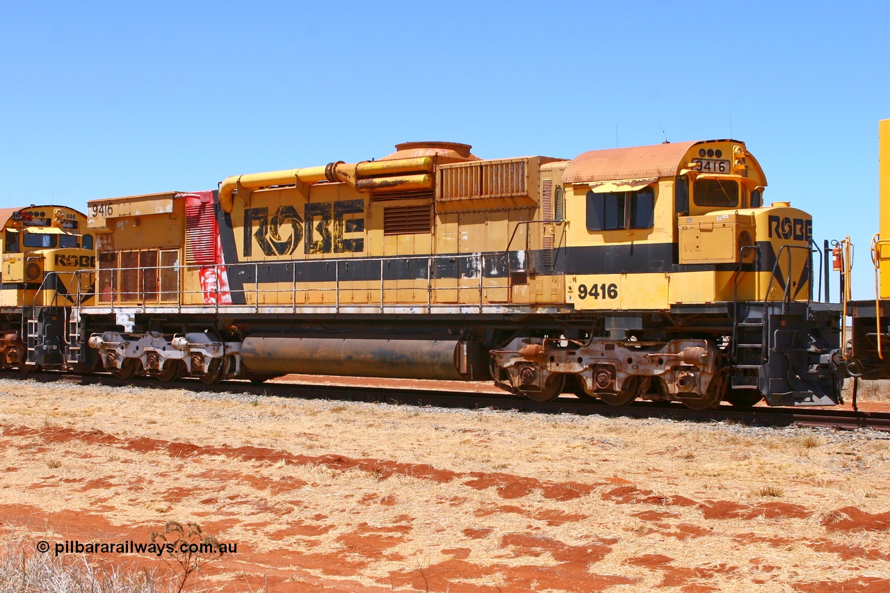 061209 8231r
Seven Mile 38 Road, former Robe River AE Goodwin built ALCo M636 unit 9416 serial G6046-16 awaits a new owner. 9416 was originally built for Hamersley Iron as #4045 and was purchased by Robe right before shipping to Hamersley Iron and entered service in February 1973. The ducting on the hood is the air to air intercooler modifications that Robe trialled. Also of note is the unit is fitted with an ALCo C630 fuel tank, swapped when the C630 units were rebuilt into the CM40-8M units. 9th of December 2006.
Keywords: 9416;AE-Goodwin;MLW-ALCo;M636;G6046-16;