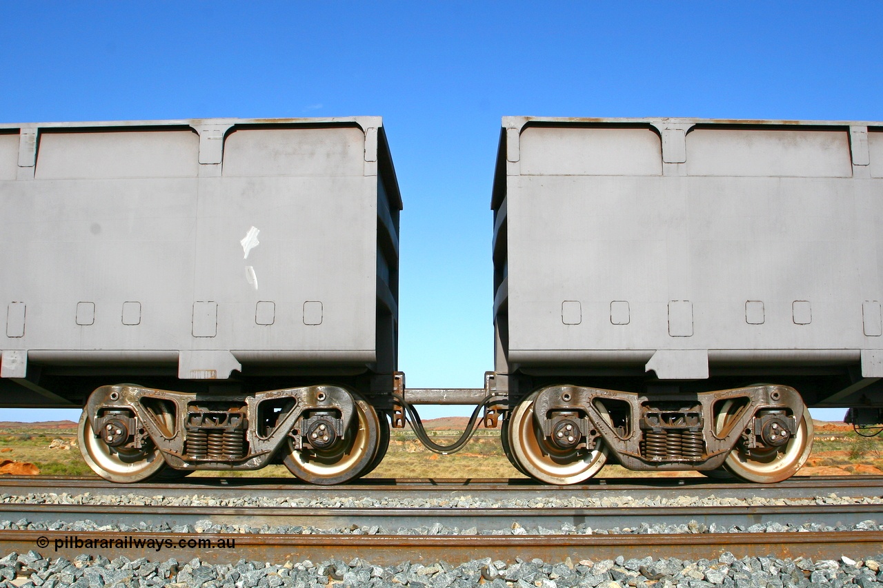 080116 1373r
Chapman Siding, view showing the bogies and bar coupling, train pipe, control pipe and electrical jumper of FMG married pair of 'slave' 1395 on the left and 'control' 2396 on the right. The BHP Newman line in the back ground. 16th January 2008.
Keywords: CSR-Zhuzhou-Rolling-Stock-Works-China;