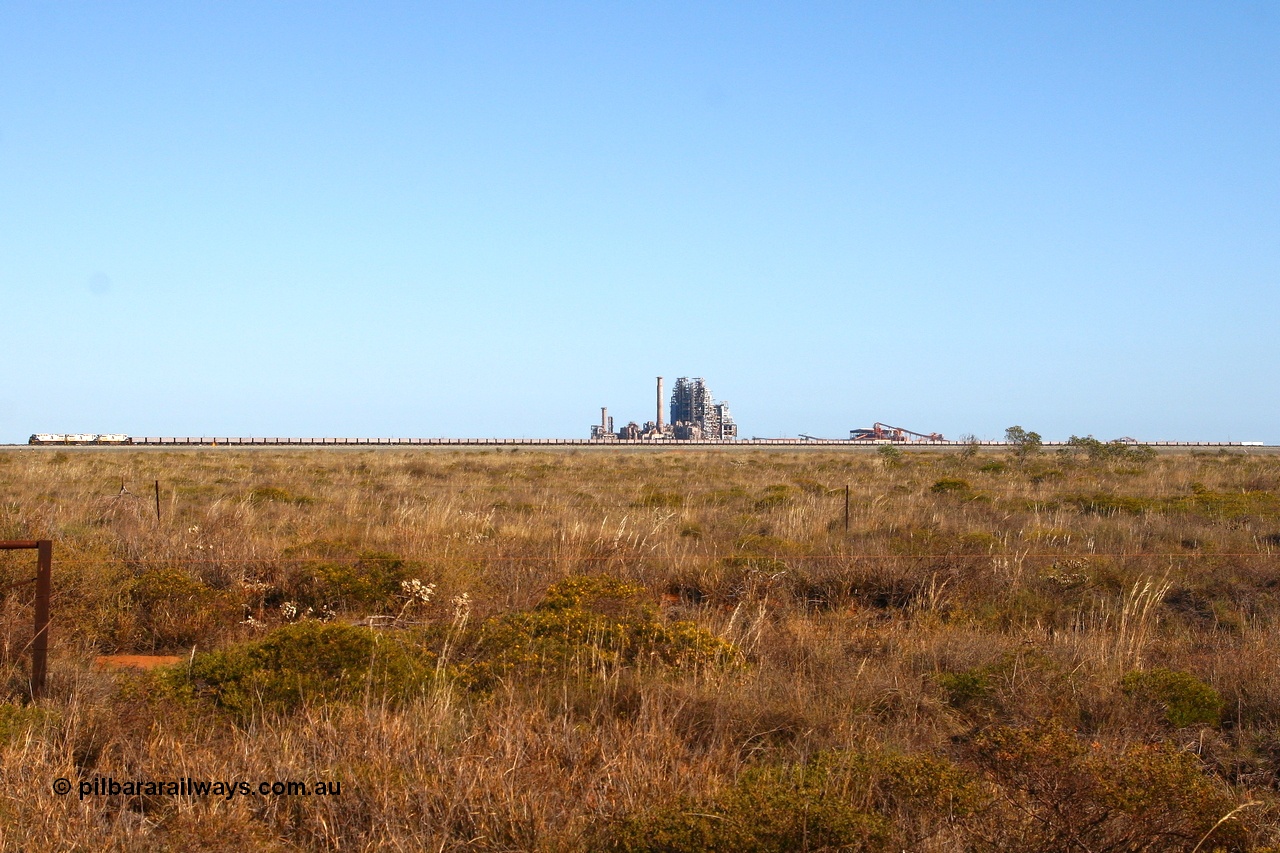 080524 2247r
Boodarie, panoramic view of FMG's General Electric built Dash 9-44CW unit 004 serial 58181 leading two sister units, 130 ore waggons and a two waggon compressor set as they pass in front of the failed BHP Billiton HBI plant. 24th May 2008.
Keywords: FMG-004;GE;Dash-9-44CW;58181;