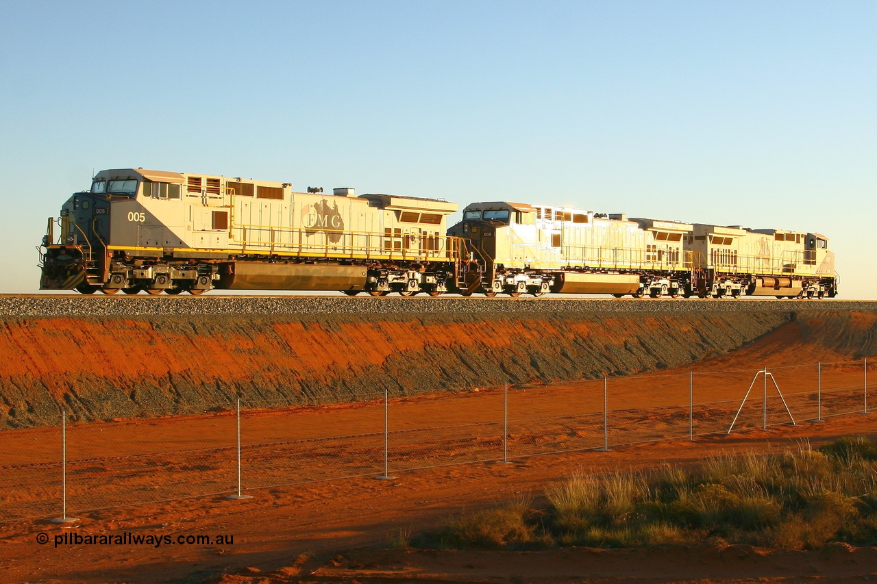 080525 2416r
Boodarie, as the sun glints off FMG's General Electric built Dash 9-44CW combo of 009 serial 58156, 008 serial 58155 and 005 serial 58182 units power around the balloon loop and towards the 4 km to stable and wait for the dumper to unload their rake. 25th May 2008.
Keywords: FMG-005;GE;Dash-9-44CW;58182
