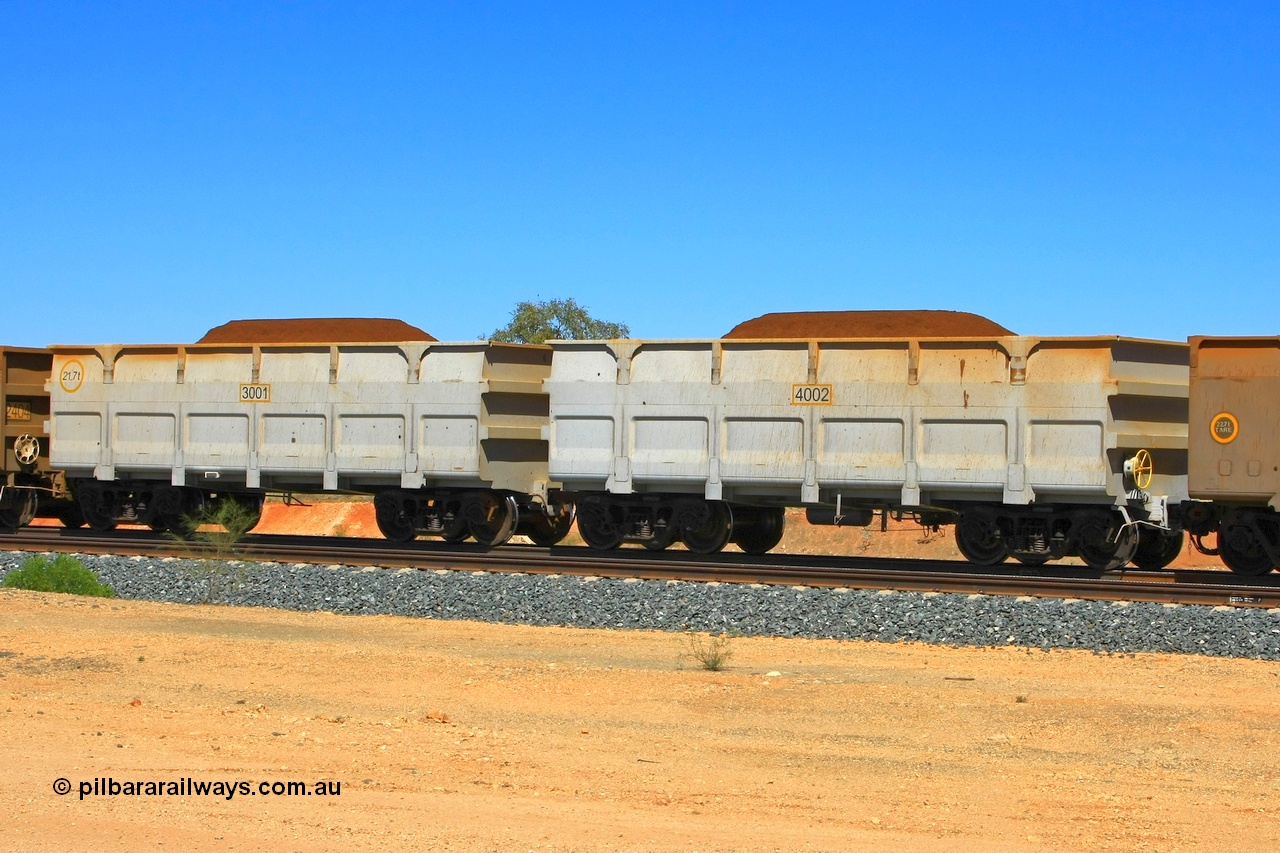 090814 2097r
Hunter Siding, FMG trial waggons built by CNR QRRS in China and one tonne lighter than the existing fleet. 3001 is the slave waggon with the rotary coupling and stencilled as 21.7 tonnes, 4002 is the control waggon and should be 21.9 tonnes. FMG now has a large fleet of these waggons built by CNR QRRS or Qiqihar Railway Rolling Stock Co. Ltd of China Northern, with the tare weights now at 22.6 tonnes. 14th August 2009.
Keywords: 3001-4002;CNR-QRRS-China;FMG-ore-waggon;