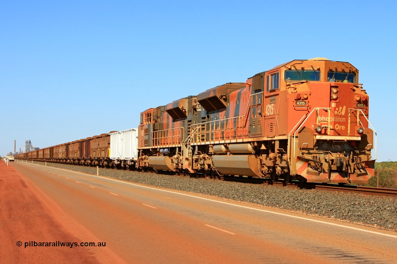 110414 0104r
Finucane Island, bit of history in this image, the second unit has been returned to the USA, the white index waggons are no longer used, the road way has been moved well left of this and a second track no occupies this road and the HBI plant in the background has been demolished. BHP Billiton's 4315 'Mijarrpa' serial 20058712-002 from the second order of EMD SD70ACe/LC locomotives built by Electro-Motive in London Ontario in October 2006 leads a loaded train towards the car dumpers at Finucane Island on what used to be the Goldsworthy Mining Ltd mainline. 14th April 2011.
Keywords: 4315;Electro-Motive-London-Ontario;EMD;SD70ACe/LC;20058712-002