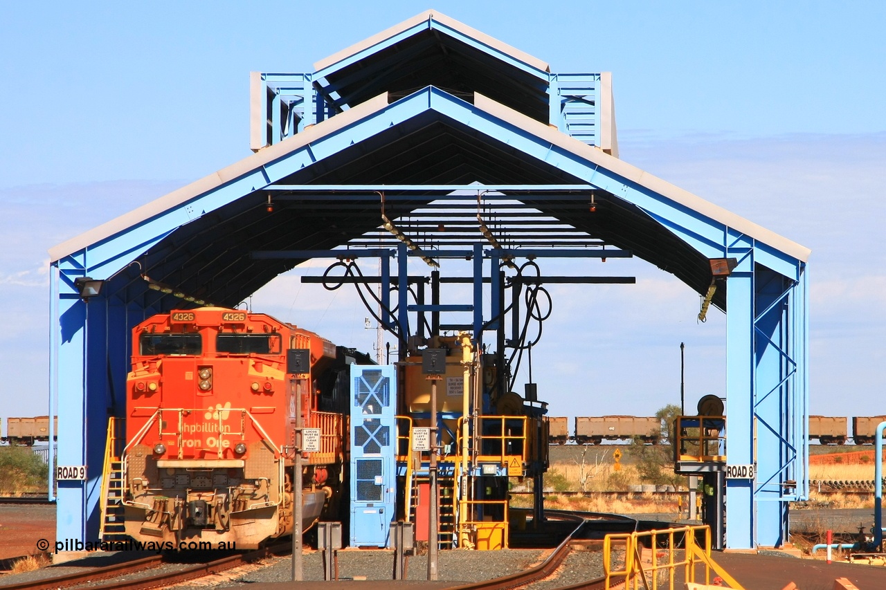 110414 0127r
Boodarie, loco prep shed see BHP Billiton 'Pumpkin' unit 4326 'Spring' serial 20066862-055 being prepped on 9 Road with the FMG dumper road in the background. 4326 was built by Electro-Motive at London Ontario originally for BNSF railroad of the USA but was part of an order for 10 standard domestic USA model SD70ACe units diverted to BHP in BNSF base pumpkin orange. The ten units underwent a significant upgrade program to see them become lead unit capable. 14th April 2011.
Keywords: 4326;Electro-Motive-London-Ontario;EMD;SD70ACe;20066862-055;BNSF-9184