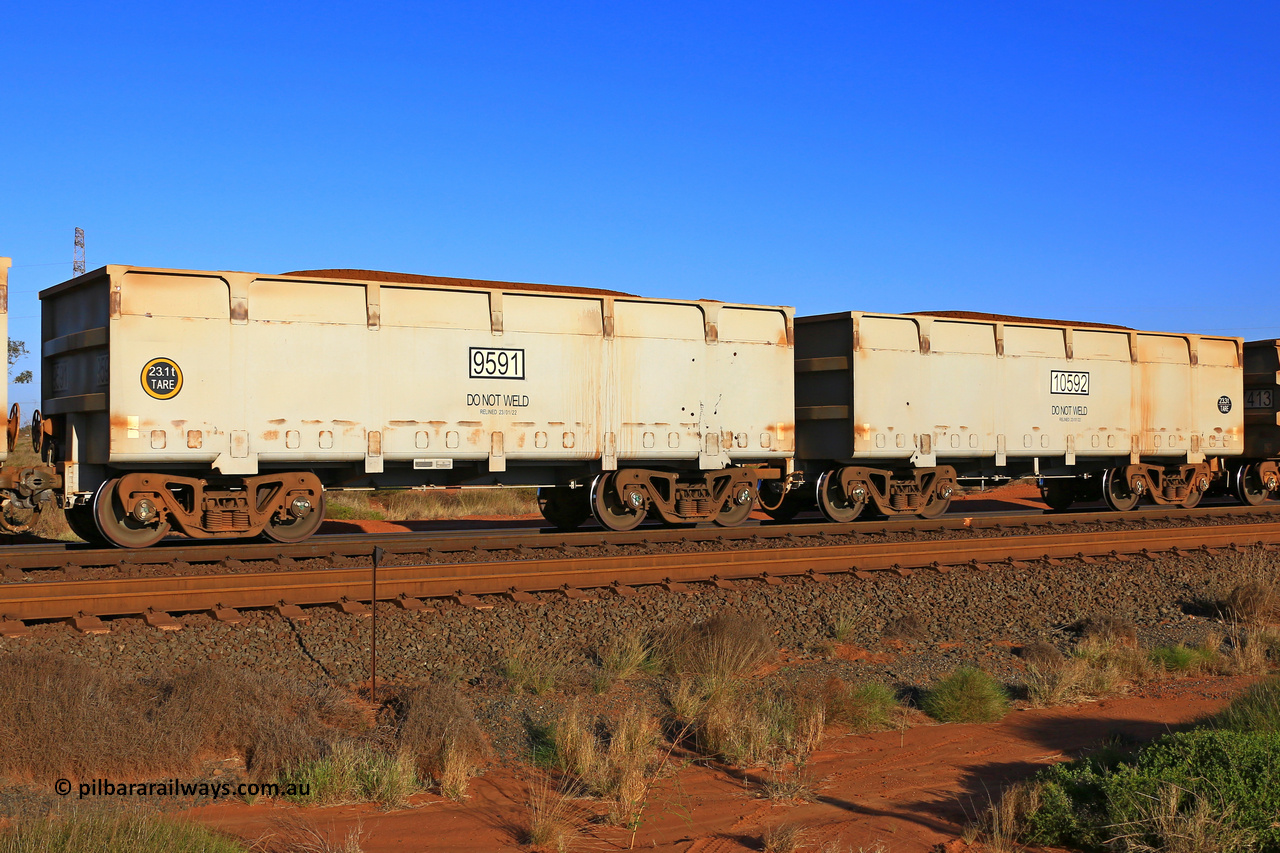 09591-10592 230902 7241
FMG 9591 and 10592 on a loaded train at Boodarie, September 2, 2023. Sixty eight waggons numbered from 9591 slave and 10592 control, up to 9657 slave and 10658 control built by CRRC Qiqihar in January and February 2022, and 9625 and higher in June 2022 with lined body stencilled DO NOT WELD and the relined date.
Keywords: 9591-10592;CRRC-Qiqihar;FMG-ore-waggon;