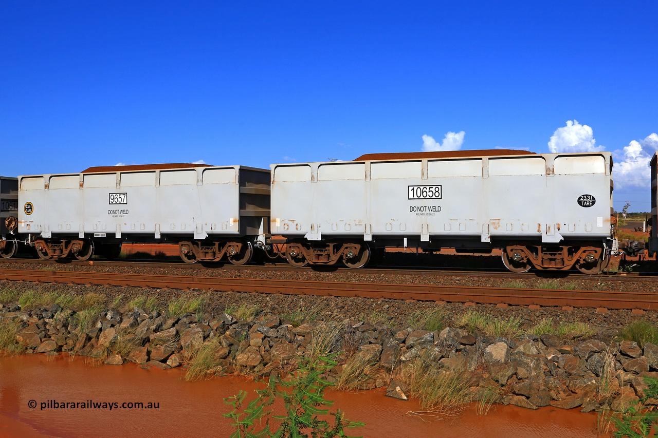 09657-10658 230309 5891
FMG 9657 and 10658 on a loaded train at Boodarie, March 9, 2023. Sixty eight waggons numbered from 9591 slave and 10592 control, up to 9657 slave and 10658 control built by CRRC Qiqihar in January and February 2022, and 9625 and higher in June 2022 with lined body stencilled DO NOT WELD and the relined date.
Keywords: 9657-10658;CRRC-Qiqihar;FMG-ore-waggon;